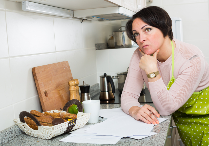 Depressed woman reading bank refuse papers about delay of payment