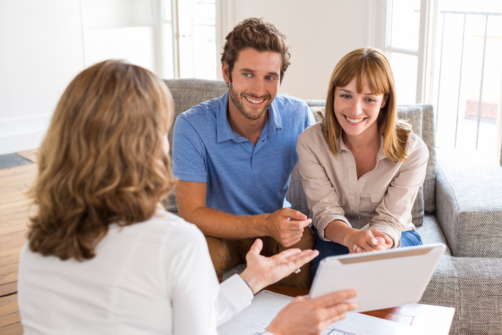 Happy young man and woman consulting plans digital PC real estate apartment
